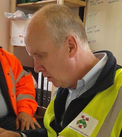 Gordon halfacre looking at paperwork as part of a site audit